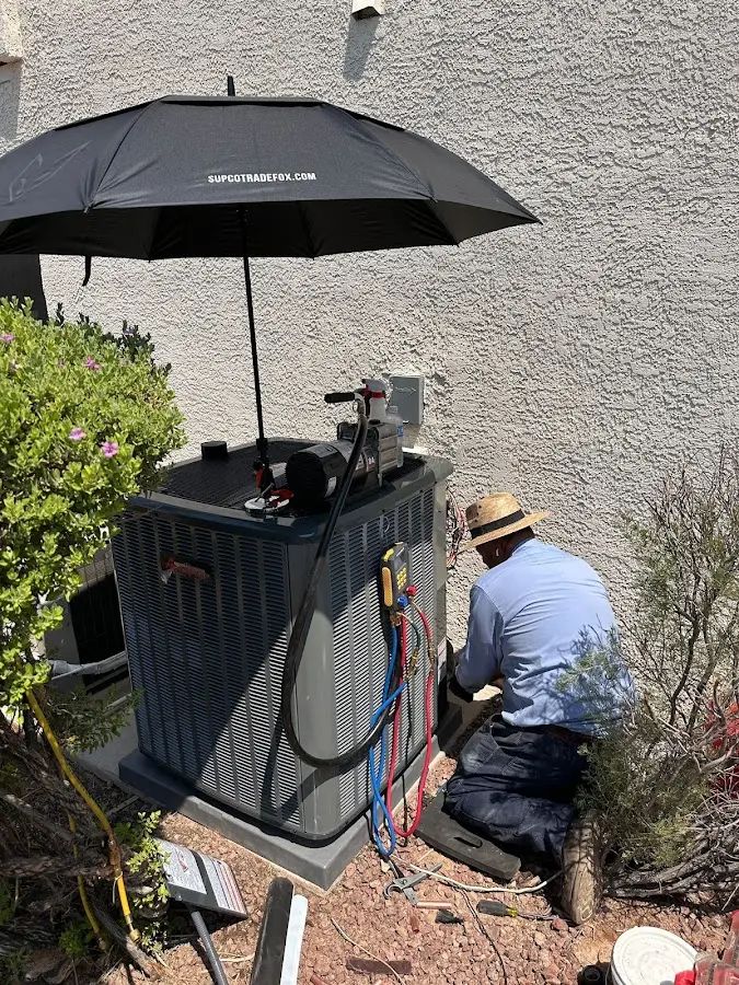 HVAC technician performing outdoor AC maintenance in Homestead